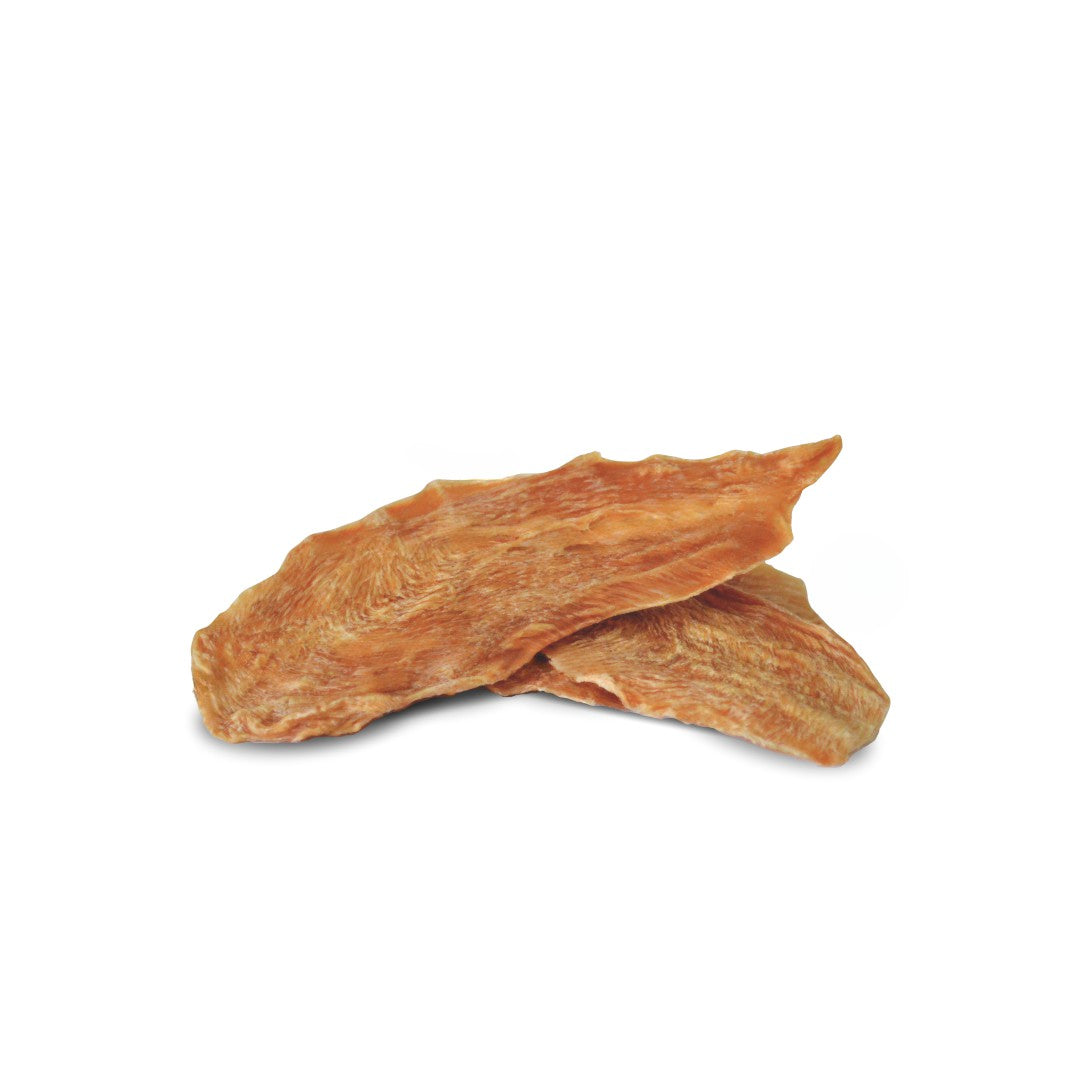 Two pieces of chicken breast dog treats on a white background